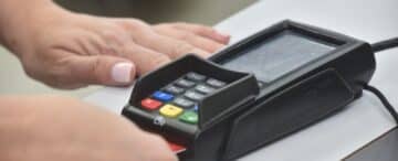 Close-up of an EMV chip card being inserted into a payment terminal. Photo by NRS.